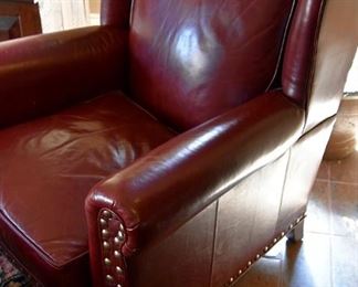red leather chair with brass nailhead detail