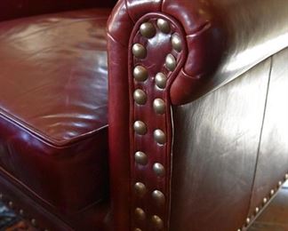 red leather chair with brass nailhead detail