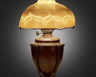 4
A Tiffany Studios Favrile Glass Table Lamp
Circa 1900-1902; New York, NY
Shade signed: L.C.T.; Base signed: Tiffany Studios / New York / [T.G.D.Co. monogram] / D 548
The gold iridescent Favrile glass shade with pulled feather motif and tones of purple and brown on a single-light patinated bronze "Greek" converted oil lamp base with glass hurricane chimney, electrified
Overall: 23" H x 12" Dia.
Estimate: $3,000 - $5,000