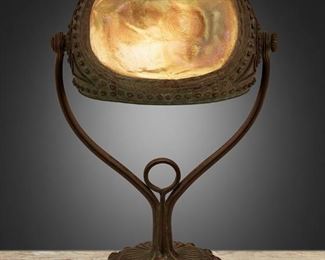 3
A Tiffany Studios "Turtle-Back" Seal Lamp
1903; New York, NY
Signed: [T.G.D.Co. monogram] / Tiffany Studios / New York / 29743
The "Turtle-Back" shade with gold iridescent glass with shades of green and hobnail design on a verdigris patinated bronze base with iridescent cabochons and floral motif, electrified
14.5" H x 8.5" W x 5.25" D
Estimate: $5,000 - $7,000