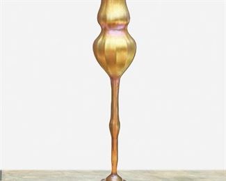 11
A L.C. Tiffany Favrile Glass Floriform Vase
1924; New York, NY
Signed: L.C.T. / Favrile / 9911 S
The gold iridescent Favrile glass floriform vase with bulbous body, triform flared lip, ribbed exterior, knopped stem, and domed base shaded to blue
17.25" H x 5" Dia.
Estimate: $1,000 - $1,500