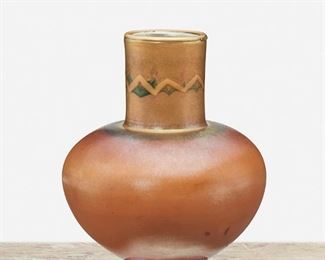 17
A L.C. Tiffany "Tel El-Amarna" Favrile Glass Vase
1917; New York, NY
Signed: L.C. Tiffany / Favrile / 5035 L
The squat globular Favrile glass vase with brown iridescent body and gold iridescent neck decorated with green and ochre geometric "Tel el-Amarna" design raised on a gold iridescent foot
6.5" H x 5" Dia.
Estimate: $1,000 - $1,500