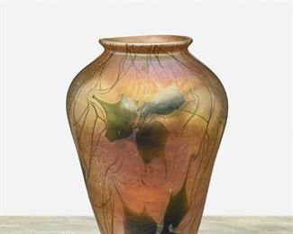 21
A L.C. Tiffany Favrile Glass Leaf And Vine Vase
1908; New York, NY
Signed: L.C. Tiffany / Favrile / 4405 C
The urn-form marbled gold iridescent Favrile glass vase with green iridescent leaf and vine motif
7" H x 5" Dia.
Estimate: $1,000 - $1,500