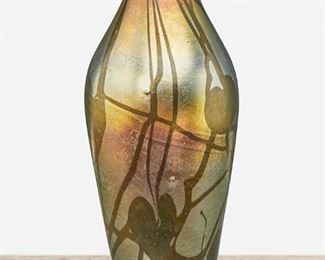 20
A L.C. Tiffany Favrile Glass Leaf And Vine Vase
1908; New York, NY
Signed: L.C. Tiffany / Favrile / 8768 C
The baluster-form gold iridescent Favrile glass vase shaded to blue with green leaf and vine motif
10.5" H x 4.75" Dia.
Estimate: $1,000 - $1,500