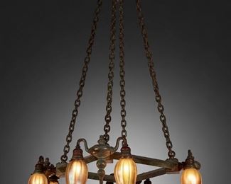 28
A Tiffany Studios Favrile Glass And Bronze Chandelier
Circa 1902-1919; New York, NY
Seven shades signed: L.C.T.; One shade signed: L.C.T. / Favrile; Bronze fixture appears unsigned
The square-form, eight-light, verdigris patinated bronze chandelier with gold iridescent Favrile glass floriform shades, turned-style corner mounts and drop finial, and suspended chain link harness, electrified
55" H x 28" W x 28" D
Estimate: $15,000 - $20,000