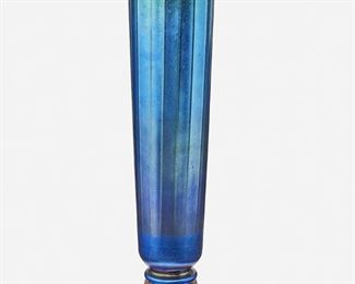 31
A Blue L.C. Tiffany Favrile Glass And Bronze Vase
Circa 1919-1928; New York, NY
Signed: Louis C. Tiffany Furnaces, Inc. / [L.C.T. monogram] / 156
The blue iridescent glass vase with tapered and ribbed cylindrical body raised on a patinated bronze foot with fluting and blue enameled teardrop designs
15.25" H x 5.25" Dia.
Estimate: $1,500 - $2,000