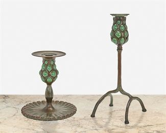 34
Two Tiffany Studios Bronze And Blown Glass Candlesticks
Circa 1902-1919; New York, NY
First signed: Tiffany Studios; Second signed: Tiffany Studios / New York / 294
Each candlestick patinated bronze, comprising one with four-legged "inverted cradle" base and green blown glass capital with removable bobeche and one with fluted oval base and green blown glass capital with wide bobeche, 2 pieces
Larger: 11" H x 4.5" W x 4.5" D; Smaller: 6.75" H x 6.25" Dia.
Estimate: $2,000 - $3,000