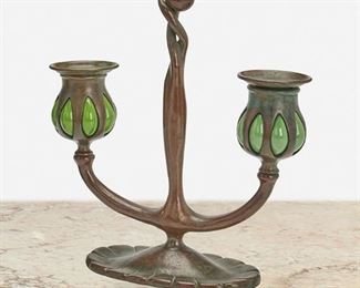 35
A Tiffany Studios Double-Arm "Bud" Candlestick
Circa 1902-1919; New York, NY
Signed: Tiffany Studios / New York / 1230 / [T.S. monogram]
The patinated bronze "Bud" candlestick with fluted oval base issuing two arms terminating in green blown glass capitals with removable bobeches
9" H x 7.75" W x 3" D
Estimate: $400 - $600