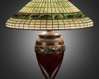 38
A Tiffany Studios "Turtle-Back" Table Lamp
Circa 1902-1919; New York, NY
Shade signed: Tiffany Studios / New York / 1489-9; Base unsigned
The green leaded glass "Turtle-Back" shade on a three-light patinated bronze base with an ovoid body supported by three arms and decorated with a "Turtle-Back" glass band, electrified
Overall: 24" H x 20" Dia.
Estimate: $15,000 - $20,000