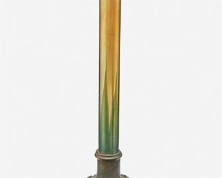 46
A Tiffany Studios Bronze And Favrile Glass Vase
Circa 1902-1919; New York, NY
Signed: Tiffany Studios / New York / 711
The cylindrical gold iridescent Favrile glass vase with green pulled feather motif on a patinated bronze base with scroll designs
14" H x 3.5" Dia.
Estimate: $800 - $1,200