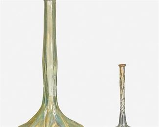 48
Two L.C. Tiffany Favrile Glass Bud Vases
Circa 1892-1893; New York, NY
Each appears unsigned; First marked: X 2120; Second marked: X 1823
Each with experimental translucent iridescence over clear glass, comprising one large vase with bulbous base and slender stem and one small vase with bulbous base and spiral stem, 2 pieces
Larger: 9.75" H x 5" Dia.; Smaller: 6" H x 2.5" Dia.
Estimate: $600 - $800