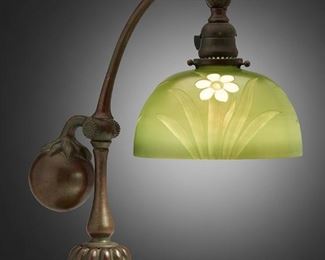 50
A Tiffany Studios Counter-Balance Desk Lamp With Intaglio Shade
Circa 1902-1918; New York, NY
Signed: Tiffany Studios / New York / 415; Shade signed: L.C. Tiffany/ Favrile / Inc / 5136 M
The intaglio Favrile glass shade with daffodils motif cut into green iridescent ground on a patinated bronze counter-balance base with stem-and-leaf design, weighted ball, and adjustable head, electrified
Base: 16" H x 8" W x 14.5" D; Shade: 8" Dia.
Estimate: $4,000 - $6,000