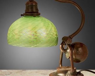51
A Tiffany Studios Counter-Balance Desk Lamp
Circa 1902-1919; New York, NY
Shade signed: L.C.T.; Base signed: Tiffany Studios / New York / 416
The green damascene Favrile glass shade with tones of blue and onion skin on a patinated bronze counter-balance "Chaflin" base with curved stem and adjustable head, electrified
Base: 14.75" H x 7" W x 10.5"D; Shade: 7" Dia.
Estimate: $3,000 - $5,000