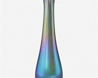 55
A Blue L.C. Tiffany Favrile Glass Triple-Throated Vase
1895; New York, NY
Signed: L.C. Tiffany / Favrile / 9548 D
The blue iridescent Favrile glass vase with tapered body and three pointed segments with a central opening
12.25" H x 3" Dia.
Estimate: $800 - $1,200