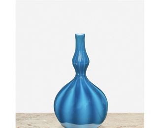 57
A Blue L.C. Tiffany Favrile Glass Bud Vase
1910; New York, NY
Signed: L.C. Tiffany / Favrile / 2534 E
The opaque blue Favrile glass bud vase with gourd-shaped body, pinched neck, and light blue stripes
7.5" H x 4.25" Dia.
Estimate: $1,000 - $1,500
