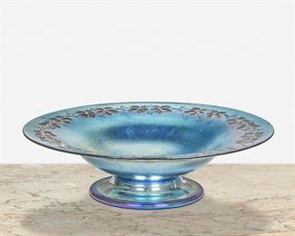 59
A Blue L.C. Tiffany Favrile Glass Intaglio Compote
First-quarter 20th Century; New York, NY
Signed: L.C. Tiffany / Favrile
The blue iridescent Favrile glass compote with an intaglio leaf and vine border
2.75" H x 9.75" Dia.
Estimate: $500 - $700