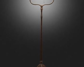 61
A Tiffany Studios Harp Floor Lamp
Circa 1902-1919; New York, NY
Shade signed: S 2544; Base signed: Tiffany Studios / New York / 423 H
The green and yellow iridescent "Wave" Favrile glass shade on a single-light patinated bronze harp base with plain stem and floral socket cover raised on five curved legs with spade feet, electrified
Overall: 57.75" H x 16" Dia.; Shade: 10" Dia.
Estimate: $7,000 - $9,000