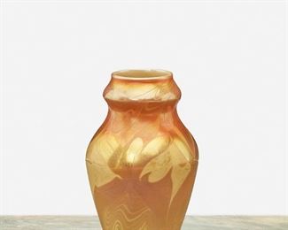 66
A L.C. Tiffany Favrile Glass Cabinet Vase
1900; New York, NY
Signed: L.C.T. / N 5350
The marbled gold iridescent Favrile glass vase with yellow swirls, wide-shouldered body, and flared neck
5.25" H x 3.25" Dia.
Estimate: $700 - $900