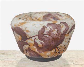 76
A Daum Cameo Glass "Lily" Bowl
First-quarter 20th Century; Nancy, France
Signed: Daum Nancy / France [Croix de Lorraine]
The acid-etched cameo glass "Lily" bowl cut from purple to mottled yellow and white frost
5.5" H x 8" Dia.
Estimate: $700 - $900