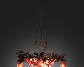 92
A Gallé Cameo Glass "Magnolia" Chandelier
First-quarter 20th Century; Nancy, France
Signed: Galle
The acid-etched cameo glass domical "Magnolia" shade cut from red to white frost and fitted with three light sockets and three drop pendants with matching shades, mounted with floral-style wrought iron border, canopy, and suspended chain link harness, electrified
39" H x 25" Dia.
Estimate: $4,000 - $6,000