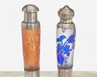 96
Two Daum Cameo Glass Perfume Bottles
Late 19th/early 20th Century; Nancy, France
Each marked for sterling; One signed: Daum Nancy [Croix de Lorraine]; One Signed: Daum [illegible]
Each acid-etched cameo glass with gilt highlights, sterling silver foot cap and lid, and glass stopper, comprising one cut from blue to clear frost with floral motif and floral designs to sterling silver and one cut from orange to orange frost with strawberry motif, 2 pieces
Larger: 6.75" H x 1.25" Dia.
9.645 gross oz. troy approximately
Estimate: $500 - $700