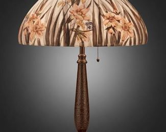 106
A Handel Reverse-Painted Glass "Daffodil" Table Lamp
First-quarter 20th Century; Meriden, Connecticut
Shade signed: Handel Lamps / Pat'd. No. 979664 / Handel / 7042 / R.G.; Base signed: Handel
The domical chipped ice finished glass shade with reverse-painted red daffodils and blades of grass against a light blue ground on a two-light patinated metal base with tapered column, circular foot, and chipped ice texture throughout, electrified
Overall: 22" H x 15" Dia.
Estimate: $2,000 - $3,000