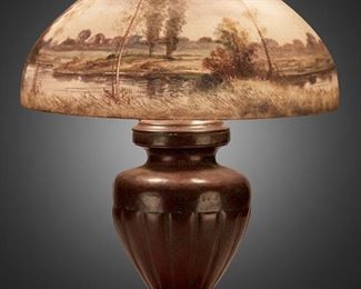 109
A Handel Reverse-Painted Glass Landscape Table Lamp
Circa 1918; Meriden, Connecticut
Shade signed: Handel Lamps / Pat'd. No. 979664 / Handel / 6638; Base signed: Handel
The domical, chipped ice finished glass shade with reverse-painted birch woodland scene in green and grey against a purple and blue twilight sky with rising moon on a three-light patinated metal base with an urn-form body raised on a square foot, electrified
Overall: 23" H x 18" Dia.
Estimate: $1,500 - $2,000