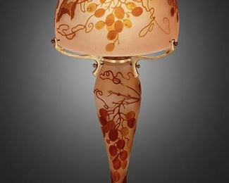 111
A Gallé Cameo Glass "Grapes And Vines" Boudoir Lamp
First-quarter 20th Century; Nancy, France
Base and shade signed: Galle
The acid-etched cameo glass "Grapes and Vines" lamp with tapering flared base and domical shade cut from amber to pink frost and fitted with metal arms, electrified
14.5" H x 6.75" Dia.
Estimate: $1,000 - $1,500
