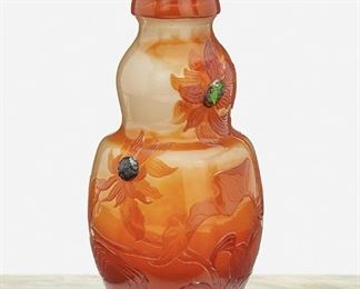 118
A Gallé Cameo Glass "Sunflower" Vase
Late 19th/early 20th Century; Nancy, France
Etched signature to underside: Galle / depose
The acid-etched, fire-polished cameo glass "Sunflower" vase cut from orange to clear with applied green glass cabochons and metallic foil inclusions
9" H x 5" Dia.
Estimate: $1,000 - $1,500