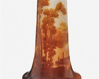 122
A Tall Gallé Cameo Glass "Paysage Du Lac" Vase
Late 19th/early 20th Century; Nancy, France
Signed: Galle
The acid-etched cameo glass cylindrical vase with wide base cut from dark amber to white and pale pink frost with wooded lakeside and boats motif
10" H x 5.75" Dia.
Estimate: $700 - $900