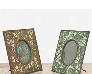 134
Two "Grape Vine" Bronze Picture Frames
First-quarter 20th Century; New York, NY
One signed: Tiffany Studios / New York / 946; One unsigned
Each rectangular patinated bronze "Grape Vine" frame with green mottled glass and bronze overlay enclosing an oval opening, comprising one with beaded border and one with verdigris patination, 2 pieces
Larger: 10" H x 8" W x 4.5" D; Opening: 5.5" H x 4" W
Estimate: $1,500 - $2,000