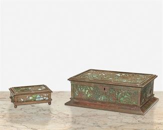 136
Two Tiffany Studios "Grape Vine" Desk Accessories
Circa 1902-1919; New York, NY
Each signed: Tiffany Studios / New York; One further marked: 832
Each mottled green glass with patinated bronze "Grape Vine" motif overlay and beaded border, comprising one humidor cigar box with cedar-lined lid and lockplate and one utility box raised on ball feet, 2 pieces
Larger: 3" H x 9.5" W x 6.5" D; Smaller: 1.5" H x 4.375" W x 3" D
Estimate: $1,200 - $1,800