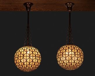 137
A Pair Of Spherical Leaded Glass Pendant Chandeliers
Circa 1900-1910
Each caramel-colored pendant chandelier of painted lead came construction with fish scale pattern fitted with a single light socket and patinated metal stem, canopy, and suspended chain link harness, 2 pieces
Each: 31" H x 10.5" Dia.
Estimate: $3,000 - $5,000