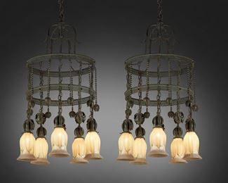 139
A Pair Of American Arts And Crafts Verdigris Chandeliers
First-quarter 20th Century; New York
Each shade signed: Quezal
Likely Riviere Brass and Bronze Works, each two-tiered verdigris patinated bronze chandelier with reticulated strapping, scrolling canopy, and floral-style ornamental hanging features with beaded and linked chains, fitted with five drop pendant lights with Quezal iridescent gold, white, and green glass shades with pulled feather motif, electrified, 2 pieces
37" H x 19" Dia.
Estimate: $3,000 - $5,000