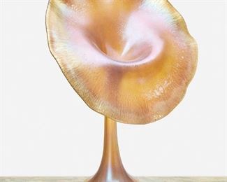 144
A Quezal "Jack-In-The-Pulpit" Vase
First-quarter 20th Century; New York, NY
Signed: Quezal / I 789
The gold iridescent glass "Jack-in-the-pulpit" vase shaded pink with heavy rounded base, slender stem, and wide blooming rim with light onion skin
14.5" H x 9.75" Dia.
Estimate: $1,000 - $1,500