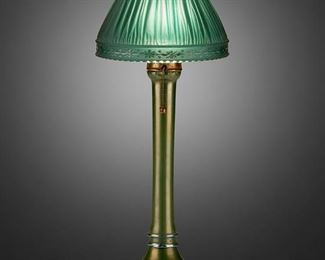 145
A L.C. Tiffany Favrile "Linenfold" Boudoir Lamp
First-quarter 20th Century; New York, NY
Base signed: L.C. Tiffany / Favrile; Shade signed: Tiffany Furnaces / Patented Oct 14 1918
The green "Linenfold," also called "Favrilefabrique," glass shade with intaglio cut floral border on a one-light iridescent green Favrile glass base with slender column and wide foot, electrified
14" H x 5.5" Dia.
Estimate: $1,000 - $1,500