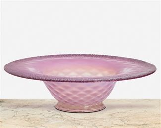 153
A L.C. Tiffany Favrile Glass Bowl
Circa 1892-1893; New York, NY
Signed: L.C. Tiffany / Favrile / 1561
The Favrile glass footed bowl in pink to clear gradation with onion skin rim, white underside, and optical base
3.25" H x 12.25" Dia.
Estimate: $800 - $1,200