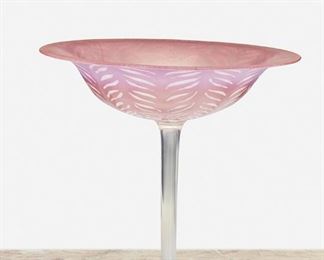 154
A L.C. Tiffany Favrile Pink Pastille Glass Compote
Circa 1902-1919; New York, NY
Signed: L.C. Tiffany / Favrile / 1293 / [L.C.T. monogram paper label]
The opalescent pastille glass compote with a flared cranberry-colored onion skin edge fading to light pink, raised on a clear stem and opaque white foot, with opaque white leaf motif throughout
8.75" H x 9" Dia.
Estimate: $400 - $600