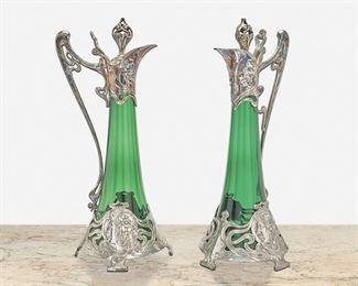 170
A Pair Of WMF Jungendstil Decanters
Circa 1910; Germany
First marked: WMFR I/0 OX / C; Second marked: WMFR I/0 AS / I
Each flared decanter with emerald green glass inserts and polished pewter mounts with floral motifs and portrait heads, raised on four feet, 2 pieces
Each: 16" H x 7" W x 6.75" D
Estimate: $1,000 - $1,500