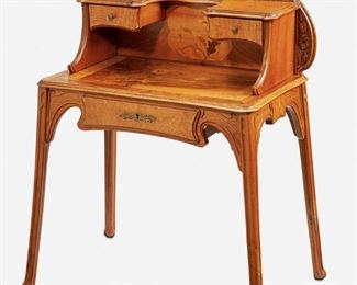 173
An Art Nouveau Marquetry Bonheur Du Jour Desk
Late 19th/early 20th Century; Nancy, France
Inscribed signature: F. Bernard / Nancy
The desk with an ovoid rear panel with low relief floral carving behind a raised compartment fitted with two flanking drawers and a floral marquetry back atop a floral marquetry top over a single frieze drawer with lockplate and raised overall on four carved straight legs with lightly flared feet
42" H x 35" W x 21.25" D
Estimate: $2,000 - $3,000
