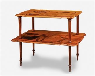 184
A Gallé Two-Tiered Marquetry Table
Circa 1885-1904; Nancy, France
Inscribed signature: Emile Galle / Nancy / EG / [Croix de Lorraine]
The rectangular two-tiered table with shaped top supported by four spiraling ribbed columns over a widening undershelf, each with marquetry flowers, foliage, and butterflies, raised overall on four spiraling ribbed legs with tapering turned feet, the upper tier with fitted glass top
31" H x 37.25" W x 26" D
Estimate: $2,500 - $3,500