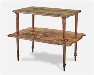 185
A Gallé Two-Tiered Marquetry Table
Circa 1885-1904; Nancy, France
Inscribed signature: Emile Galle / Nancy / EG / [Croix de Lorraine]
The rectangular two-tiered table with shaped top supported by four fluted columns over a widening undershelf, each with marquetry flowers, foliage, and butterflies, raised overall on four fluted legs with tapering turned feet, the upper tier with fitted glass top
30.5" H x 37.25" W x 25.75" D
Estimate: $2,500 - $3,500
