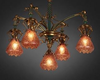 187
An Art Nouveau Gilt-Bronze Chandelier With Loetz Art Glass Shades
First-quarter 20th Century
Each shade marked: AG 552-B
The green painted and gilt-bronze chandelier with coil wrapped column issuing four arms with free-form arm backs and one central pendant, terminating in five red and yellow Loetz floriform craquele glass shades, electrified
26" H x 25" Dia.
Estimate: $1,000 - $1,500