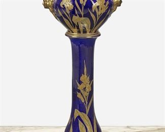 196
A French Art Nouveau Porcelain Jardinière And Stand
Late 19th/early 20th Century
Signed: JP / France / [castle]
Each with gilt iris motif against a cobalt blue ground, comprising a wide-shouldered basin with tapered rim and opposed figural masks raised on a tapered columnar plinth, 2 pieces
44.75" H x 21" W x 15" D
Estimate: $700 - $900