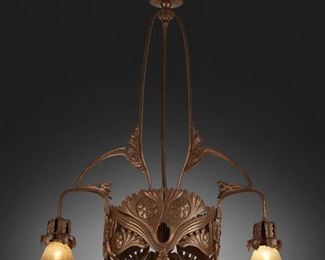 198
An Art Nouveau Patinated Metal Chandelier
First-quarter 20th Century
The three-light patinated metal chandelier with canopy, triform column, and repousse floral skirt issuing three arms terminating in green iridescent Bohemian glass shades with pulled feather motif, electrified
42" H x 26" Dia.
Estimate: $800 - $1,200