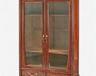 203
An Art Nouveau Walnut Double-Door Bookcase
Late 19th/early 20th Century
The walnut bookcase with arched bonnet with high relief carved lily pads atop two glazed doors with gilt-metal handles and an adjustable shelved interior over two drawers with gilt-metal handles raised on four bracket feet
96" H x 52" W x 20" D
Estimate: $2,000 - $3,000