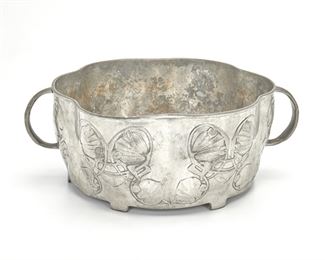 206
An Archibald Knox For Liberty & Co. Tudric Pewter Bowl
First-quarter 20th Century; England
Marked: Tudric / 0755 / 7 / Made in England
Designed by Archibald Knox for Liberty & Co. of London, the scallop-form footed pewter bowl with opposed handles and low relief Celtic Revival-style scrolling foliage raised on six feet
4.25" H x 11.25" W x 8.75" D
Estimate: $400 - $600