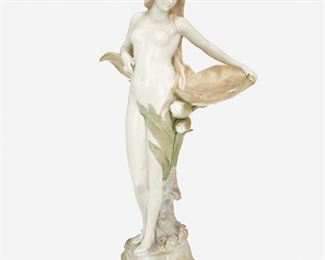 216
An Austrian Jugendstil Ceramic Standing Nude
Late 19th/early 20th Century; Austria
Marked: Made in Austria / 4638 / 1
The ceramic standing nude depicting a female figure surrounded by pink and green lily pads atop a rocky base with sea shells
16.5" H x 7.5" W x 6" D
Estimate: $500 - $700