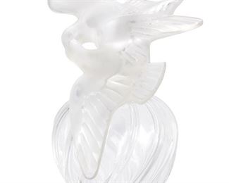 234
A Lalique Glass Perfume Bottle For Nina Ricci L'Air Du Temps
Mid-20th Century
Signed: Lalique
The large perfume bottle with a ribbed, spiraled body and frosted glass double dove stopper
12.5" H x 7.5" W x 6" D
Estimate: $500 - $700