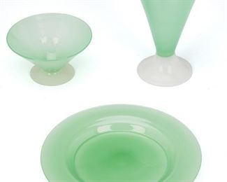 235
A Set Of Steuben Jade And Alabaster Glass Dishes
Second-quarter 20th Century; Corning, New York
Each signed: Steuben
Each of jade glass, comprising six plates (.5" H x 8.5" Dia.), six flared sherbet glasses on alabaster feet (2.5" H x 5" Dia.), and six flared lemonade glasses on alabaster feet (6.5" H x 4.25" Dia.), 18 pieces
Estimate: $800 - $1,200